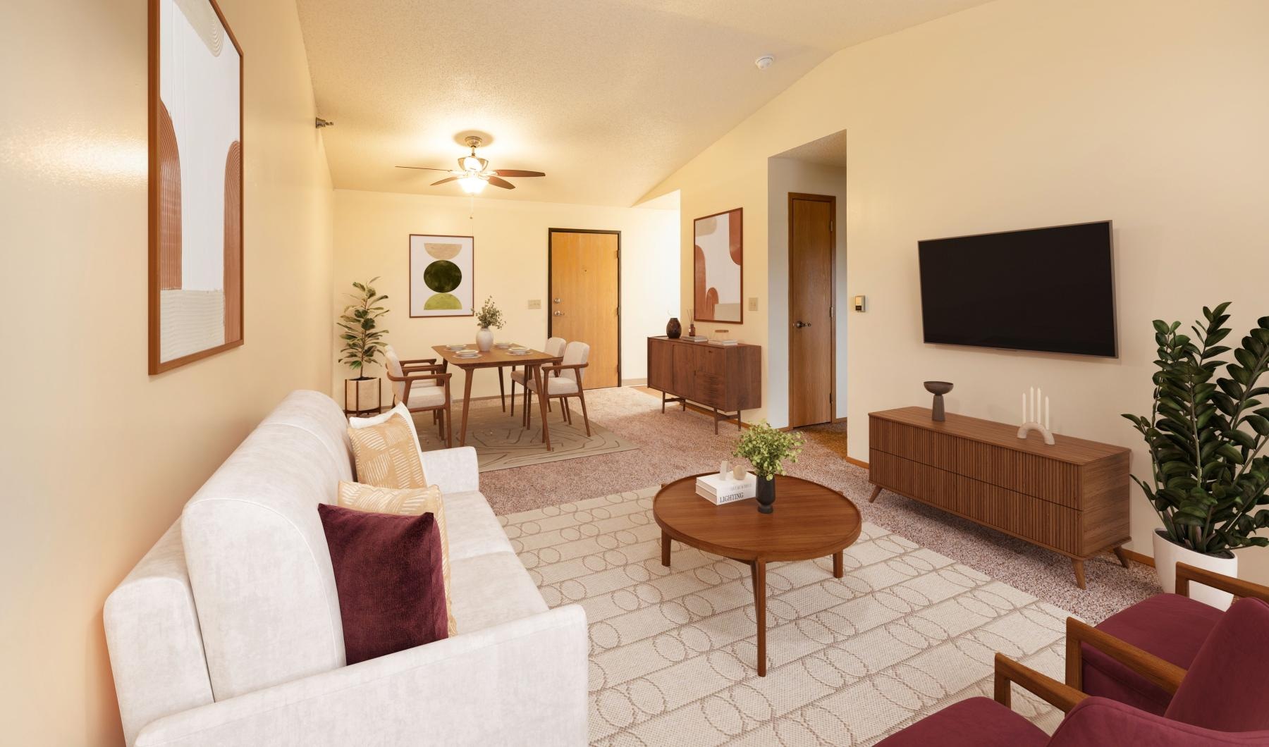 a living room with a tv, couch, table and chairs
